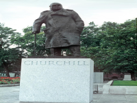 The statue of Winston Churchill on the grounds of the Houses of Parliament building  in London